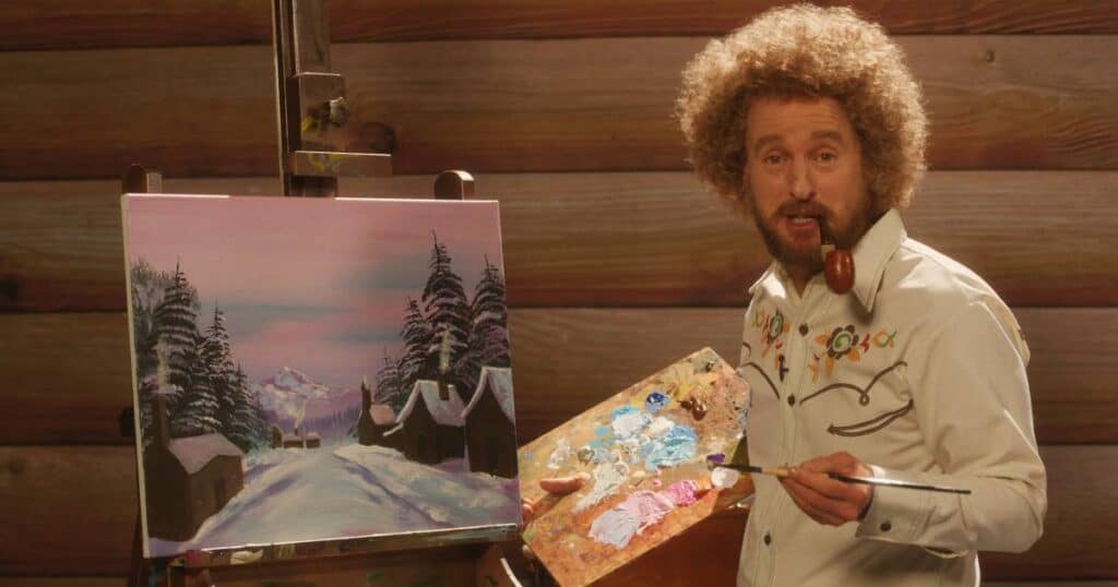 Owen Wilson admits his Bob Ross wig does the “heavy lifting” in Paint
