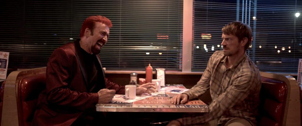 Nic Cage and Joel Kinnaman in Sympathy for the Devil (2023).