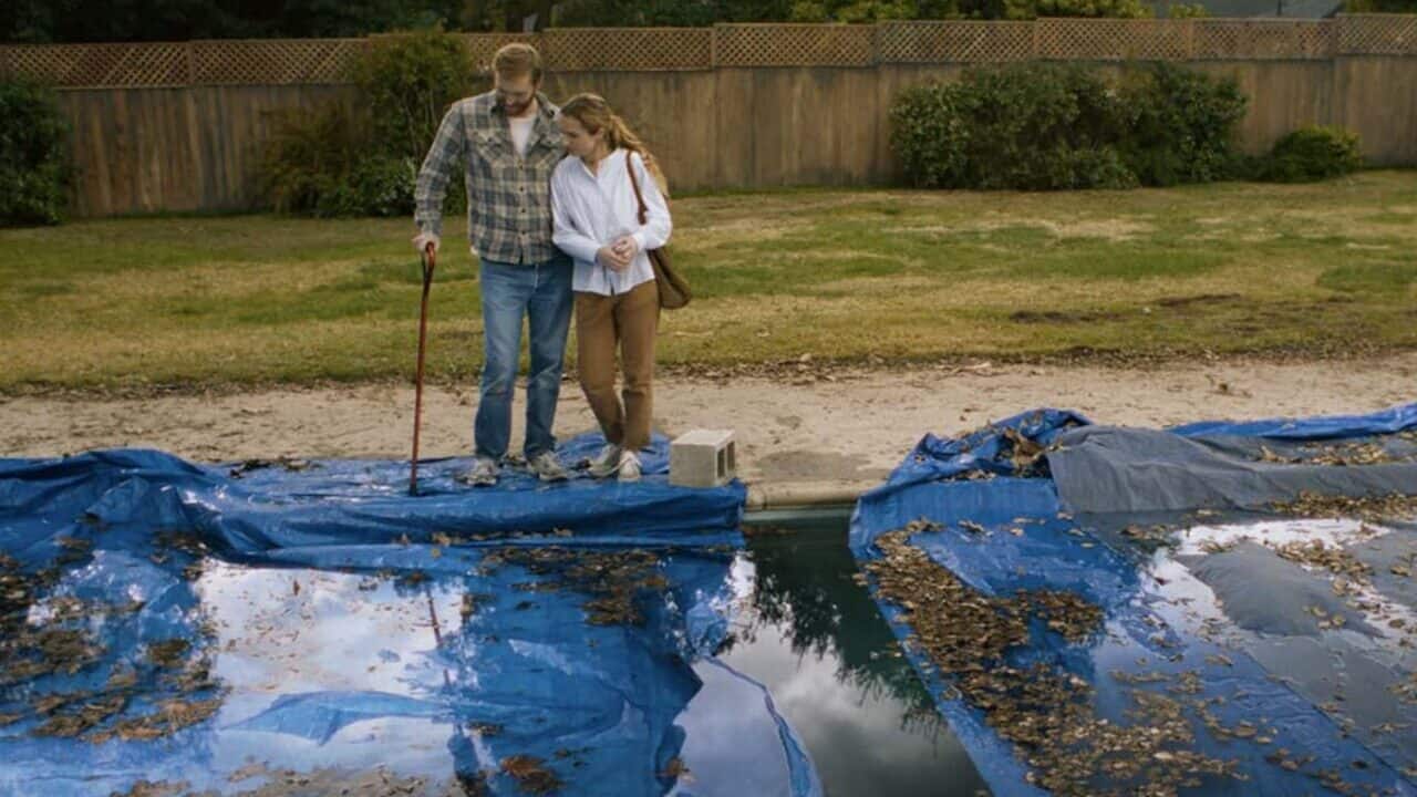 Wyatt Russell and Kerry Condon check out their pool in Night Swim (2024).